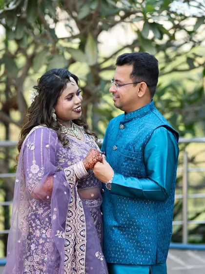 A candid engagement photo capturing a sweet, interactive moment between the couple as they hold hands.
