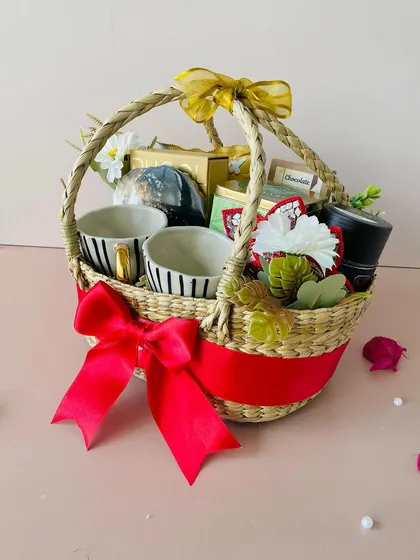 Another view of the Kauna oval basket, showing the beautiful striped ceramic mugs and other premium items nestled inside.