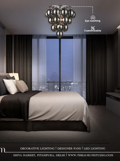 This cluster of smoked glass globes forms a modern chandelier, adding a touch of customizable, moody sophistication above the bed. It provides a soft, ambient glow perfect for a contemporary bedroom sanctuary.