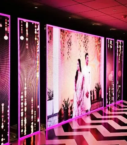 Another view of the multi-panel LED stage, showing how it wraps around the performance area. The chevron-patterned dance floor and vibrant lighting create an electrifying atmosphere for the Sangeet.