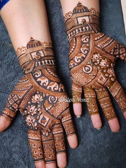 An elaborate design featuring elephants, lotuses, and architectural dome motifs, perfect for a bride.