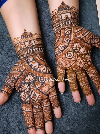 An elaborate design featuring elephants, lotuses, and architectural dome motifs, perfect for a bride.