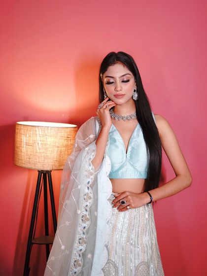 The craftsmanship on this lehenga is just beautiful. This close-up highlights the intricate embroidery and the scalloped border of the net dupatta.