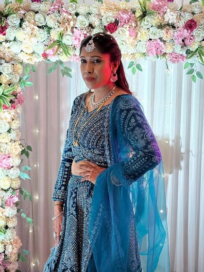 A client looking gorgeous in a blue velvet lehenga with silver embroidery. This is a great option for a reception or cocktail party.