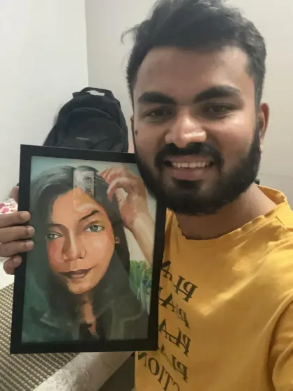 A happy client holding his framed portrait, which is a mix of realism and sketch styles.