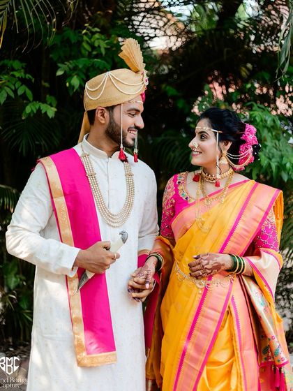 A classic portrait of the Maharashtrian bride and groom. Their traditional attire and happy smiles make for a timeless wedding photograph.