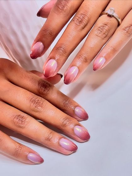 This angle showcases the beautiful shine and reflection of the chrome finish on these ombre nails.