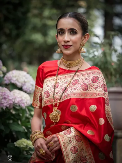 A portrait from the traditional jewelry shoot, with the model framed by soft purple flowers.