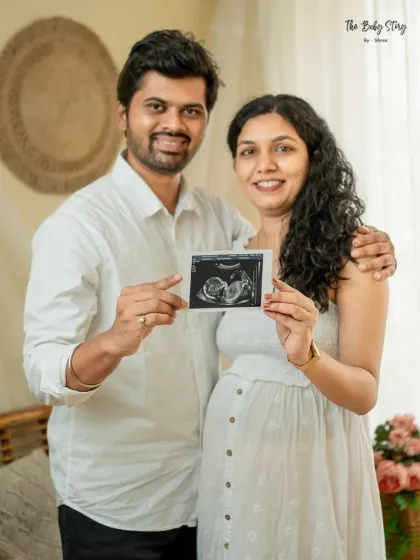 A happy couple portrait featuring their sonogram. This is a wonderful way to include the baby in the maternity shoot and create a cherished memory of the very beginning.