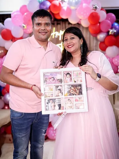 Another happy shot of the parents with their custom-made keepsake, a testament to a year of love and growth.