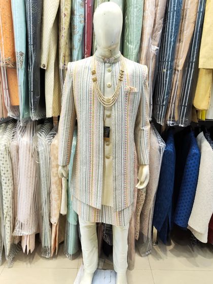A full-length view of our multi-color striped open sherwani on a mannequin, showing how it creates a tall, elegant silhouette.