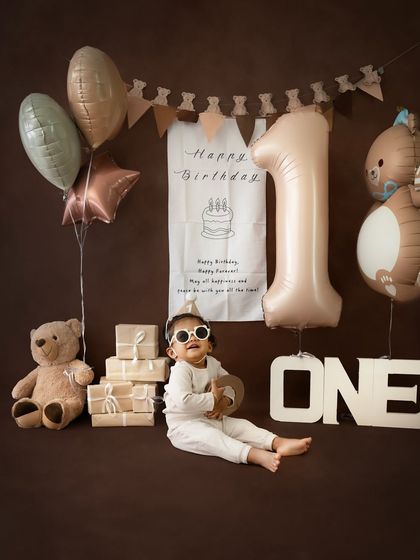 Adding a touch of cool to the first birthday shoot with a pair of sunglasses. This shows how we can personalize the session to match your baby's personality.