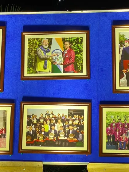 A close-up of the photo display, showcasing key moments with dignitaries like the Prime Minister. I ensure these displays are well-lit and professionally presented to give them the importance they deserve.