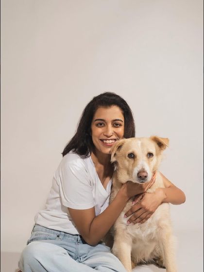 Another heartwarming portrait of a woman and her dog. The simple white background keeps the focus on their sweet connection.