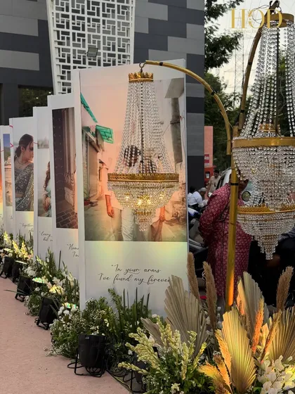 A close-up of the photo gallery entrance, where chandeliers are creatively placed to illuminate the couple's pictures and love quotes.