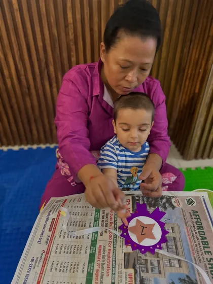 The bond between a child and their caregiver is at the center of everything we do. This quiet moment of a grandparent and toddler working together on an arts and crafts project shows the focus and connection that our activities foster.