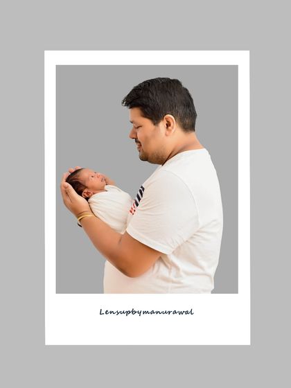 A simple, polaroid-style portrait of a father holding his newborn. This modern framing gives a classic, heartfelt moment a fresh and contemporary feel.
