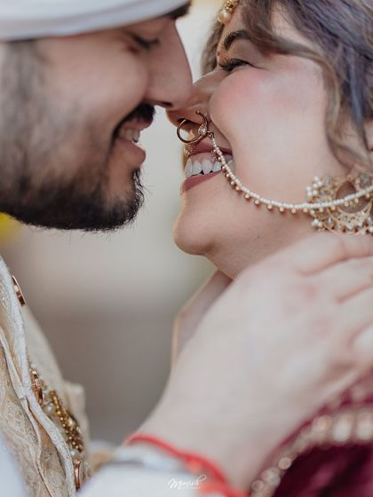 An extreme close-up capturing the shared laughter and intimacy between the newly married couple, a perfect candid wedding moment.