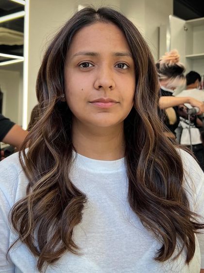 A beautiful brunette with soft highlights. A great hair day can make you feel amazing, and this client is definitely having one.