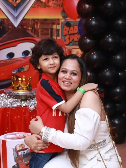 A warm hug in front of the custom Cars birthday backdrop. These are the precious moments that make every party I plan truly special.