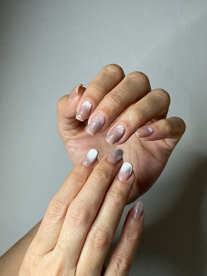 A beautiful example of a vertical ombré, blending from white to a soft, shimmery cat-eye pink.