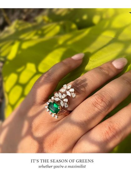 For the maximalist who loves the green trend, this statement emerald ring is perfect. A large central emerald is surrounded by a cascade of diamond leaves.