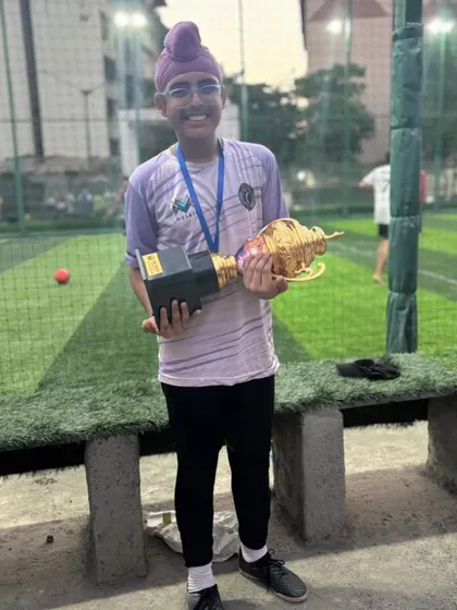 One of our U-15 players, who was awarded Best Defender, holding the team's runner-up trophy.