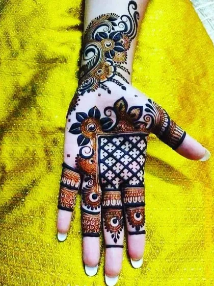A striking Arabic-style design with bold floral elements and a checkered pattern on the palm. The dark, clean lines make this design stand out.