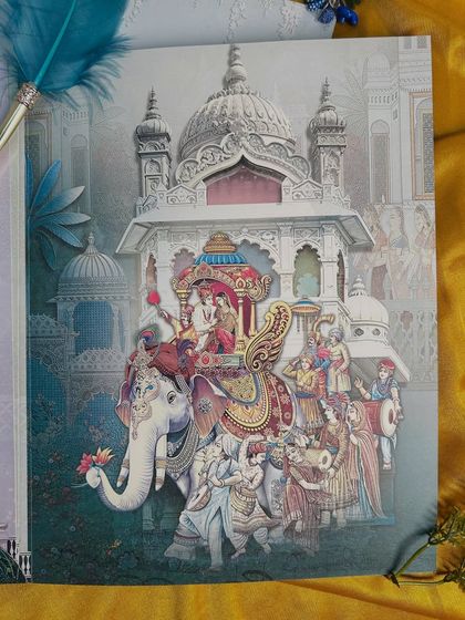 This insert captures the grandeur of a royal procession, with a beautifully adorned elephant carrying the couple, a classic baraat scene.