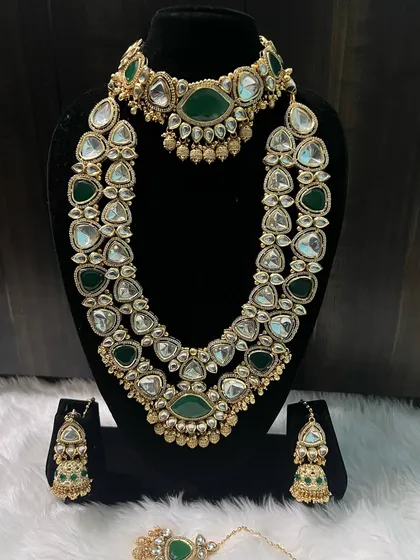 The full view of the green Kundan set, including the beautiful jhumka earrings. It's a complete, ready-to-wear rental solution for your big day.
