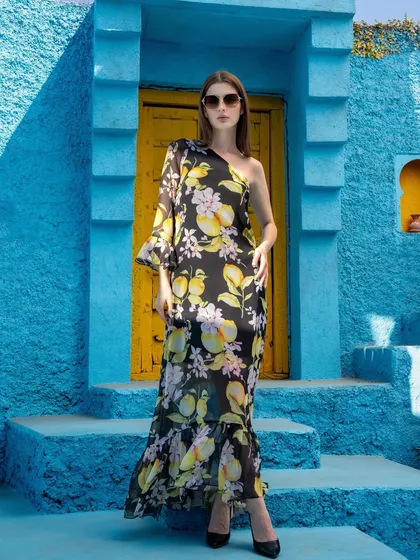 A full-length shot of a one-shoulder dress from the Tangerine Tiger campaign. The addition of sunglasses and a confident pose elevates this from a simple product shot to a complete fashion statement.