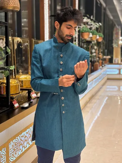 Just fixing my cuff. Another look at this smart sherwani, perfect for any sangeet.