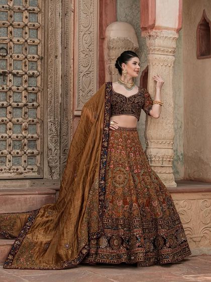 The full, majestic look of our brown bridal lehenga from "The Bridal Saga". The flowing dupatta and detailed embroidery create a truly regal silhouette.