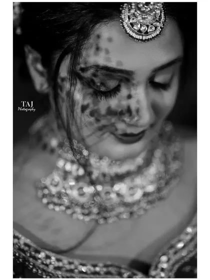 An artistic black and white bridal portrait with a shadow overlay. This creative effect adds texture and emotion to her serene expression.