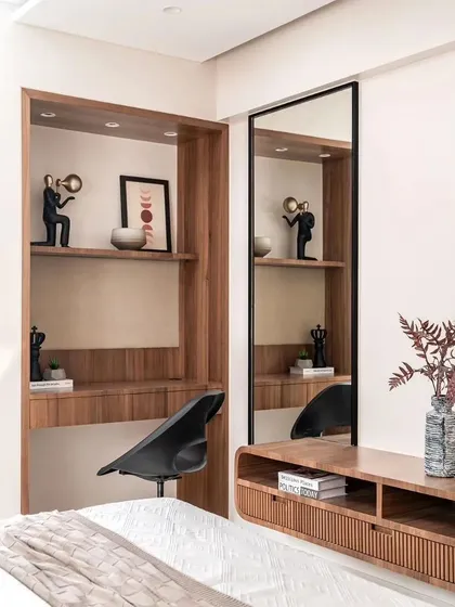 A compact study nook is cleverly integrated into the bedroom, providing a functional workspace without compromising on style.