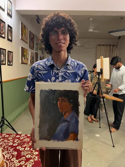 Ember holding their finished portrait. It's always a joy to see the model with the final artwork, a culmination of a shared creative experience.