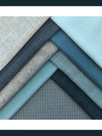 An artful composition of various blue and grey textured fabrics, highlighting my focus on material quality and visual harmony.