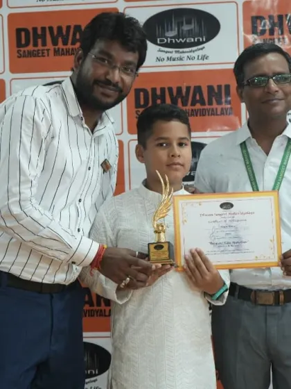 A student receives his award from our faculty, a proud moment for him and his family.