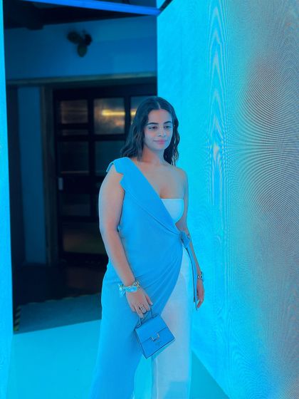 Another look at my blue and white outfit in a cool, blue-lit corridor. The one-shoulder design is a great way to draw attention to the upper body.