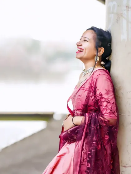 A moment of pure, uninhibited laughter. This candid shot captures the joy and beauty of the model in her festive attire.