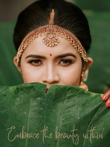 "Embrace the beauty within." An artistic close-up of the bride, peeking over a large green leaf. This creative portrait is both mysterious and beautiful.