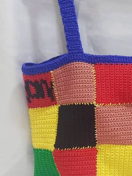 A close-up of my Harry Styles inspired patchwork cardigan top. The colorful squares and embroidered details are a tribute to the iconic original, handmade with my own twist.