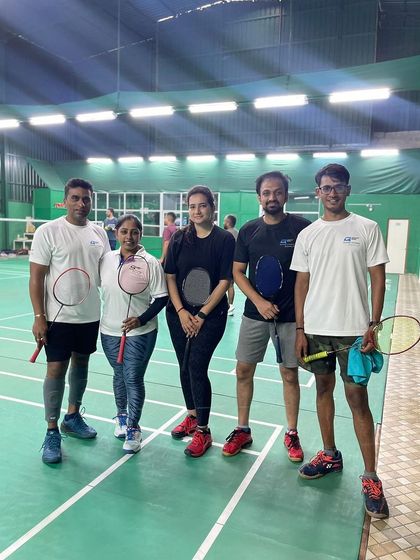 The Quadz team ready for action at a local badminton tournament. We encourage our members to pursue their athletic passions.