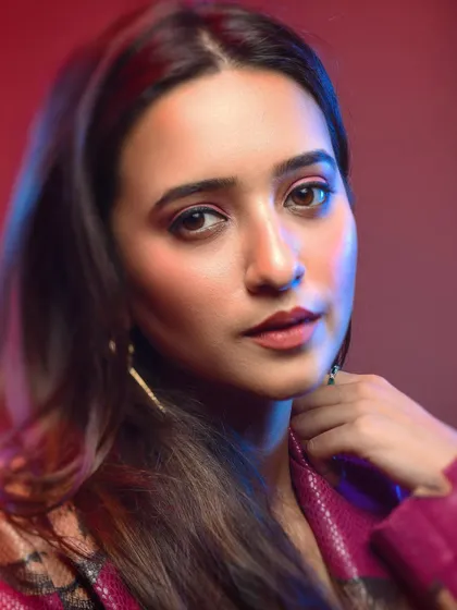Using a softer focus can add a different feel to a cinematic portrait. The blend of red and blue light combined with the model's gentle expression creates a more romantic and thoughtful mood within the same series.