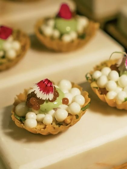 A close-up of my Surti Chaat amuse-bouche. This dish features crisp shells filled with dahi pearls, tamarind caviar, and chutney foam, showcasing how I deconstruct and elevate traditional chaat flavors.