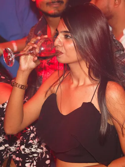 A guest enjoying a glass of red wine.