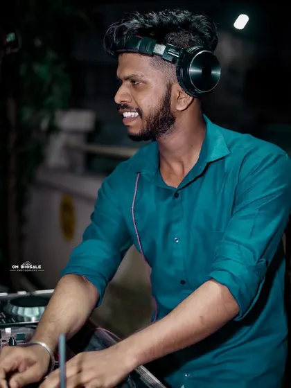 Here I am in my element, doing what I love. A good DJ doesn't just play music; I connect with the crowd, feel the energy, and make sure everyone is having an unforgettable time. This is a typical shot of me at a night event, focused on the mix.