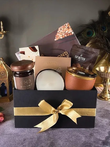 The 'Royal Dazzle' hamper is designed to impress. This premium gift box features a mix of gourmet snacks and elegant decor items, perfect for a special festive gift.