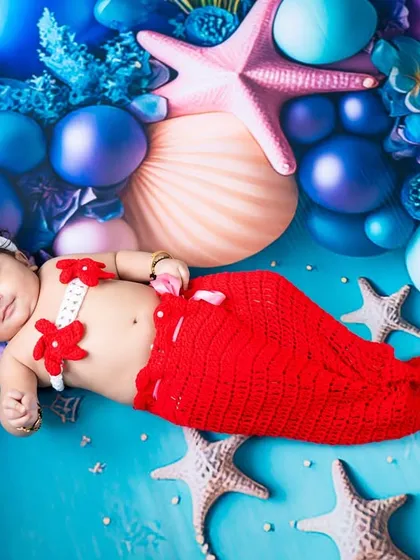 Let's dive into a world of imagination. This little mermaid is enjoying her magical underwater world, a custom theme I designed with colorful props and a knitted mermaid tail to make her dreams come true.