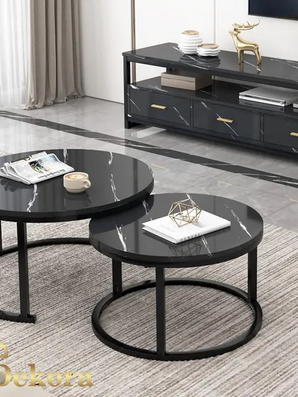 We designed this modern nesting coffee table set for flexible living spaces. Featuring two round tables with a black marble-finish top and minimalist black metal frames, they can be used together or separately to adapt to your needs.
